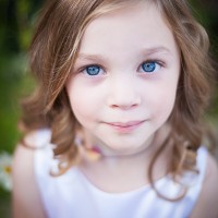 Should You Buy A Better Camera Body or Lens? Flower Girl at a Wedding by Kim Olson